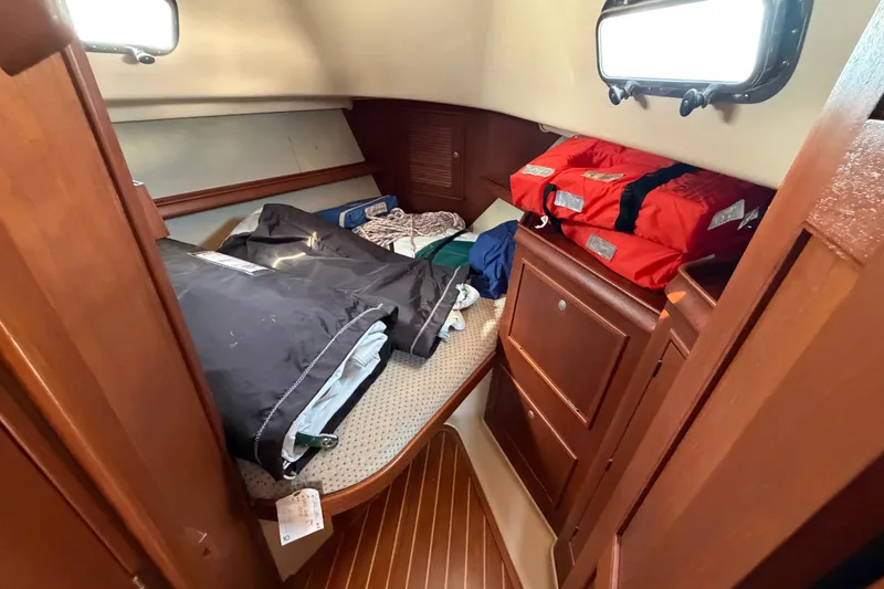 Slide: The Image of Cozy cabin interior of 2000 Island Packet 320 sailboat with storage and life jackets. - 72