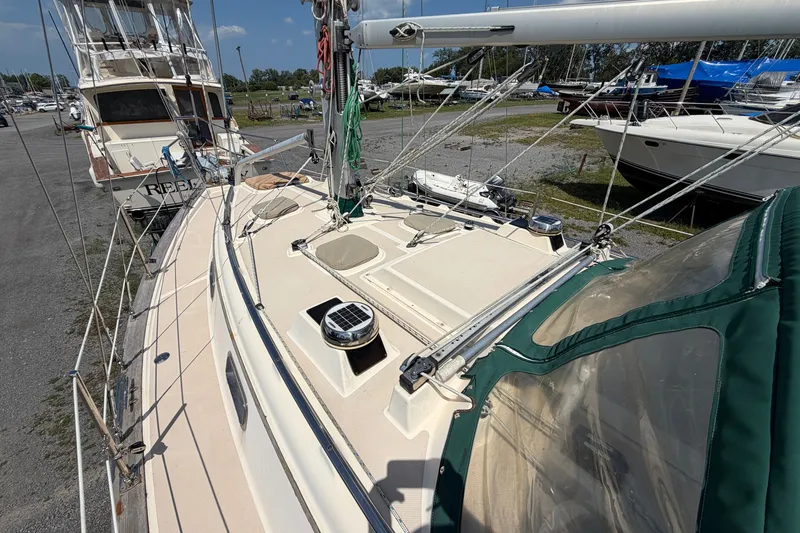 Slide: The Image of Island Packet 320 sailboat, 2000 model, docked with visible deck and rigging. - 25