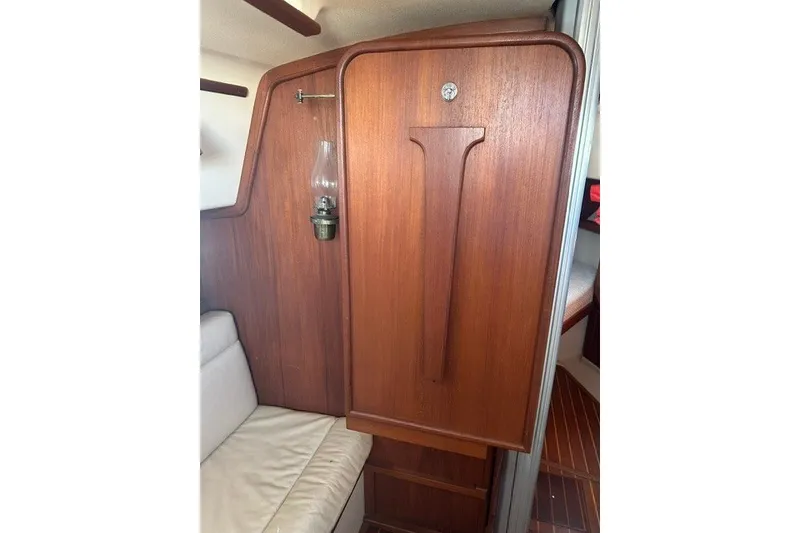Slide: The Image of Interior of 2000 Island Packet 320 sailboat with wooden cabinetry and oil lamp. - 64