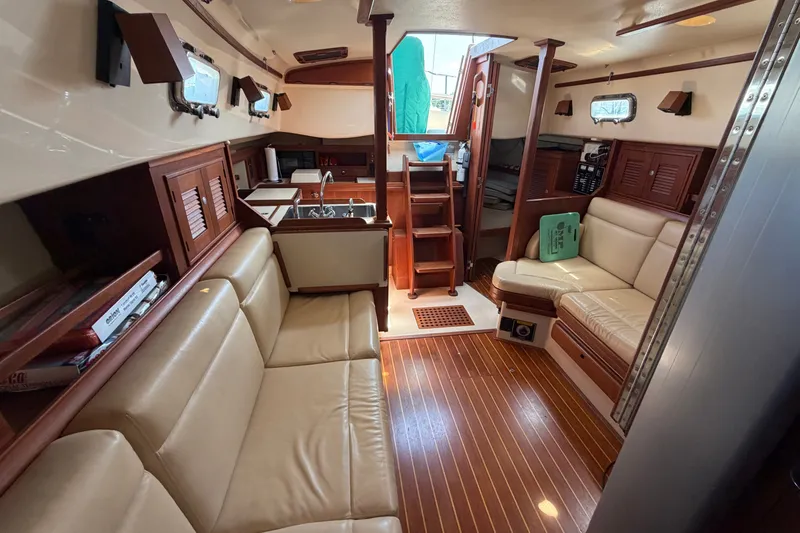 Slide: The Image of Interior of 2000 Island Packet 320 sailboat with cozy seating and wooden finishes. - 74
