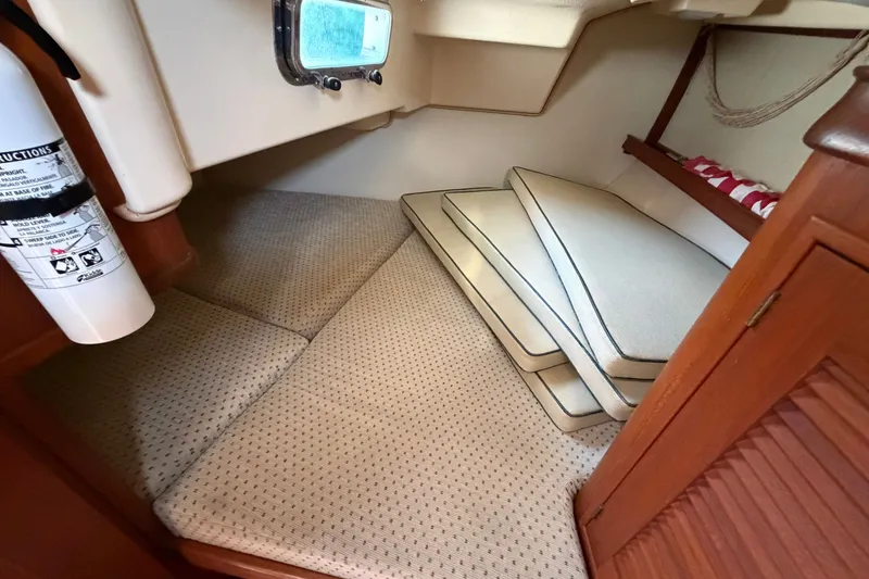 Slide: The Image of Interior cabin of 2000 Island Packet 320 sailboat with cushions and fire extinguisher. - 68