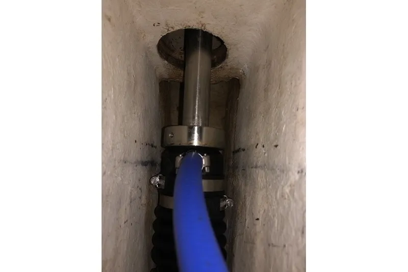 Slide: The Image of Close-up of a 2000 Island Packet 320 sailboat's shaft seal with blue hose attachment. - 85