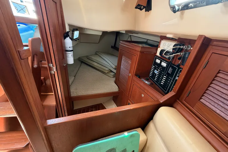 Slide: The Image of Interior of 2000 Island Packet 320 sailboat with wood cabinetry and navigation panel. - 67