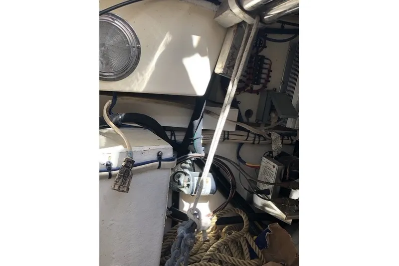 Slide: The Image of Interior view of a 2000 Island Packet 320 sailboat, showcasing ropes and electrical components. - 94