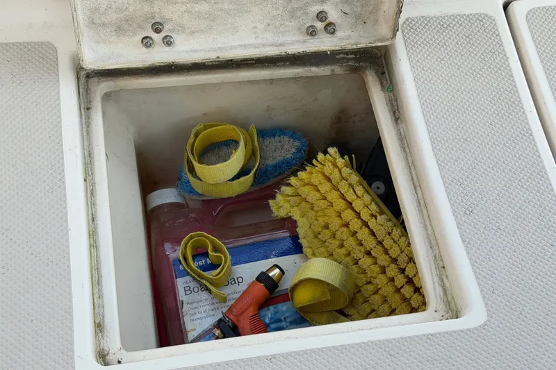 Slide: The Image of Storage compartment on 2000 Island Packet 320 sailboat with cleaning supplies and tools. - 46