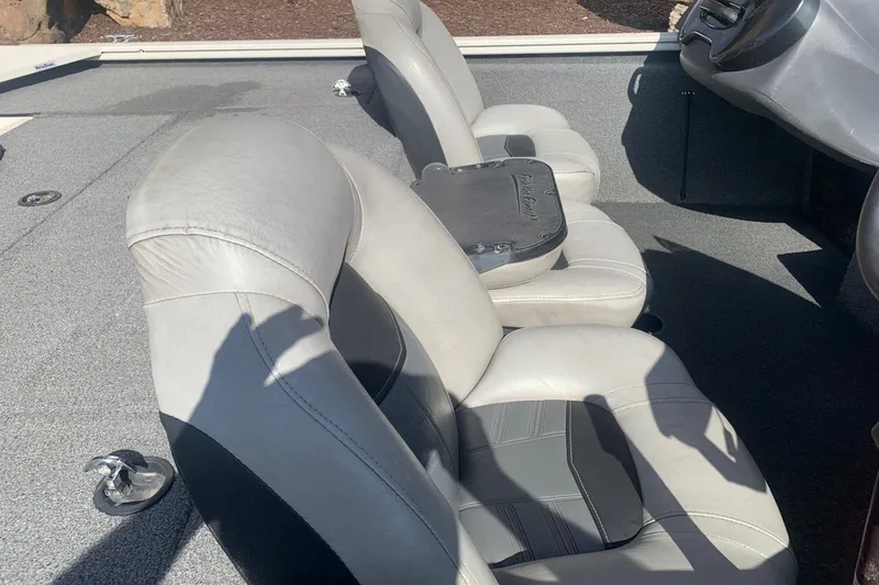 Slide: The Image of 2018 Tracker Pro Team 195 TXW boat interior with gray seating and console. - 10