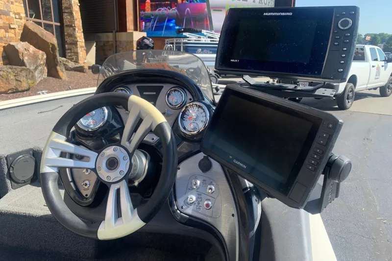 Slide: The Image of 2018 Tracker Pro Team 195 TXW boat dashboard with steering wheel and navigation screens. - 4