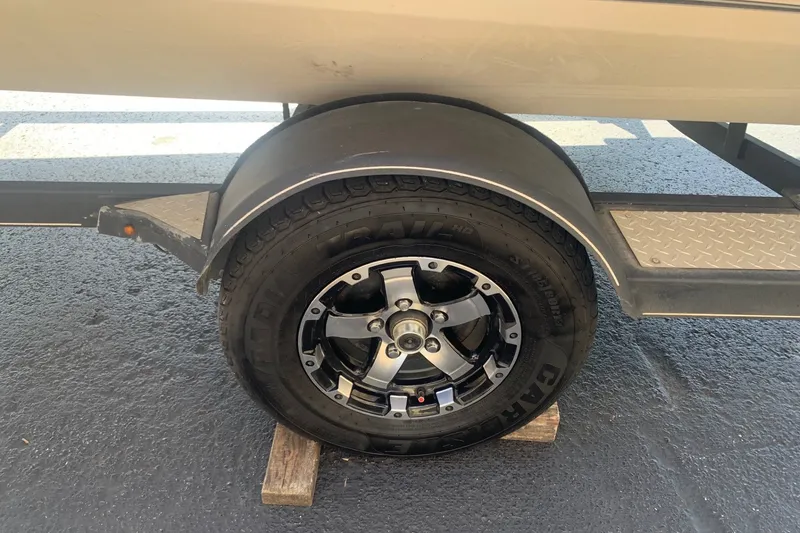 Slide: The Image of Trailer wheel of 2018 Tracker Pro Team 195 TXW boat on pavement. - 13