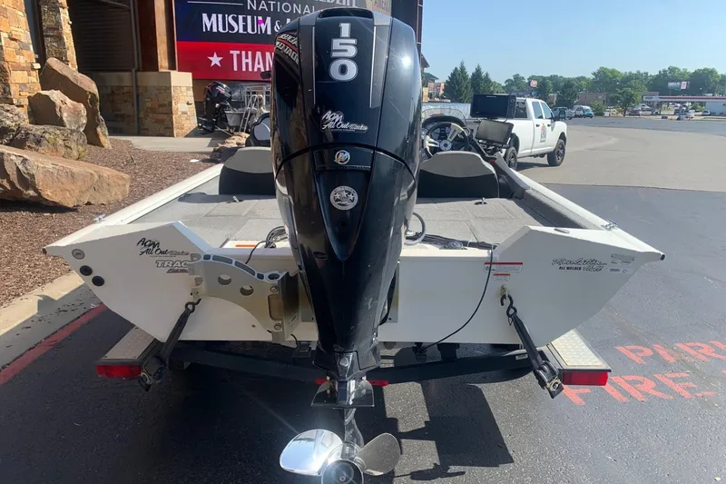 Slide: The Image of 2018 Tracker Pro Team 195 TXW boat with powerful outboard motor in parking lot. - 8