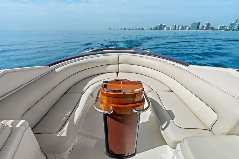 Slide: The Image of Luxurious 2006 Riva 33' Aquariva boat interior with white seating, ocean view, and city skyline. - 10