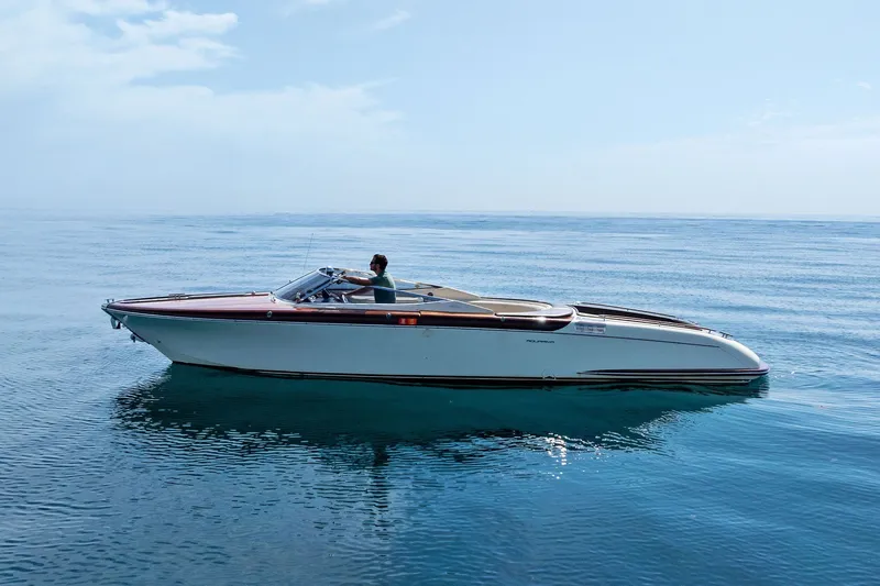 Slide: The Image of 2006 Riva 33' Aquariva boat cruising on calm blue waters under a clear sky. - 4