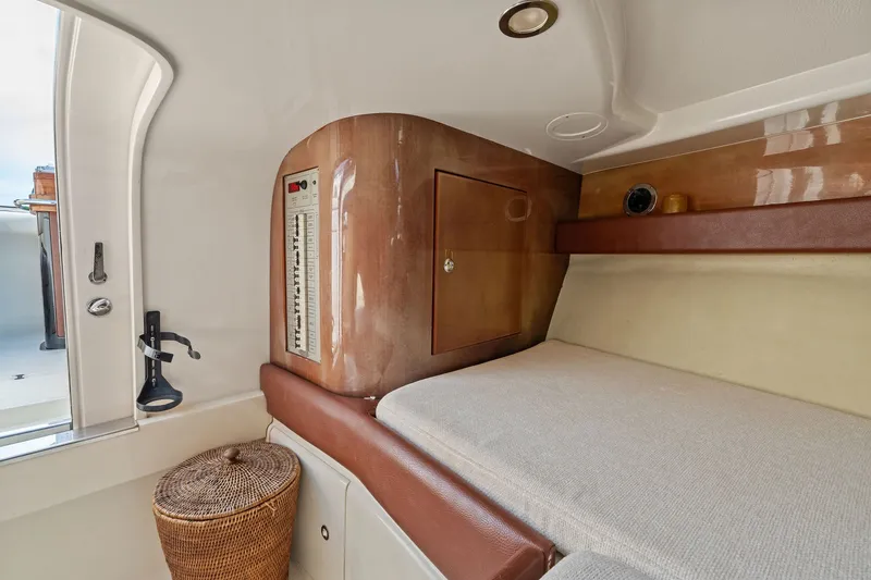 Slide: The Image of Interior cabin of a 2006 Riva 33' Aquariva yacht with wood paneling and cozy bed. - 22