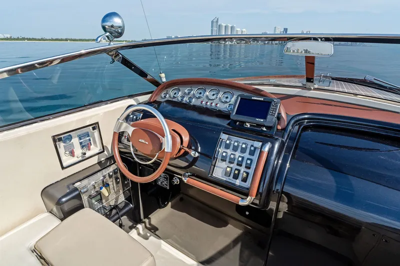 Slide: The Image of 2006 Riva 33' Aquariva boat dashboard with steering wheel and navigation system. - 14