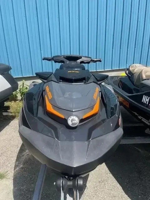 Slide: The Image of A black 2022 Sea-Doo GTX 170 SS iDF on a trailer, set against a blue wall. - 2
