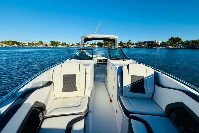 Slide: The Image of 2020 Monterey 328SS Super Sport boat on a sunny day, cruising on a calm lake. - 15