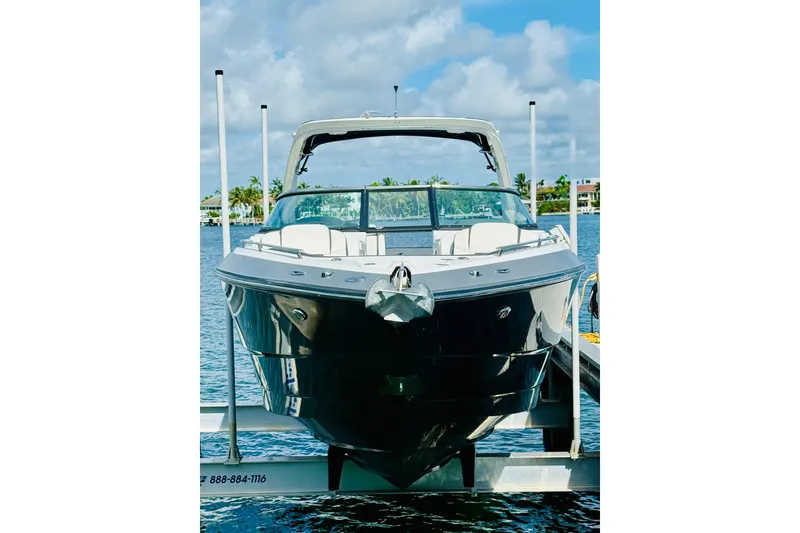 Slide: The Image of 2020 Monterey 328SS Super Sport boat docked on a sunny day. - 2