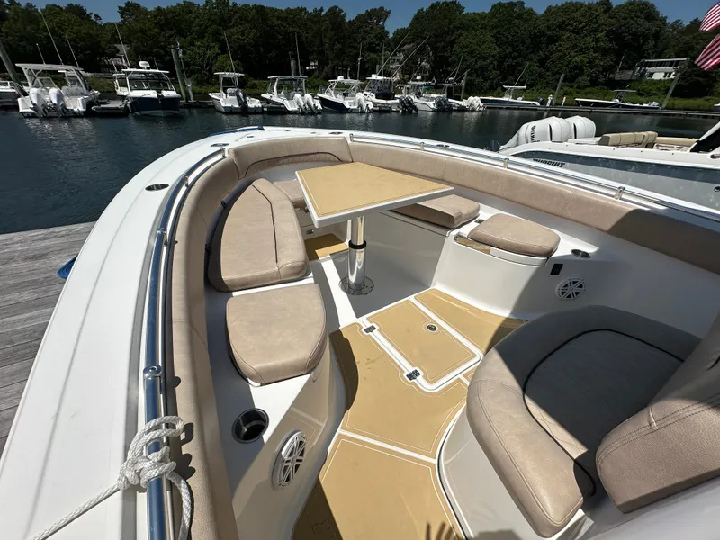 Slide: The Image of The image shows the cockpit of a 2019 Sportsman Open 282 Center Console boat with beige upholstery. - 14