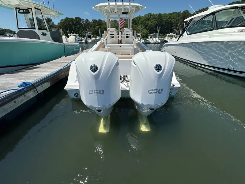 Slide: The Image of The image shows a 2019 Sportsman Open 282 Center Console boat with two outboard engines. - 37