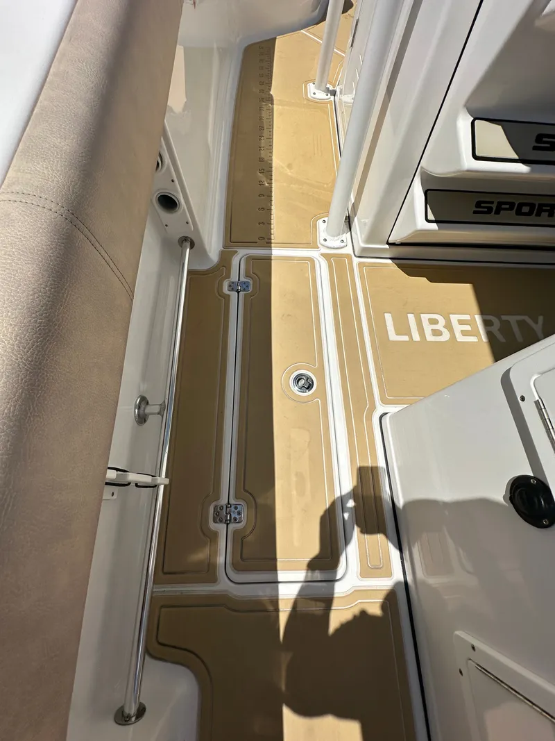 Slide: The Image of Deck view of a 2019 Sportsman Open 282 Center Console boat with beige flooring. - 17