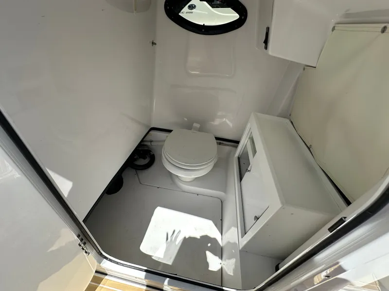 Slide: The Image of Interior view of a boat with a toilet and a small sink. - 30