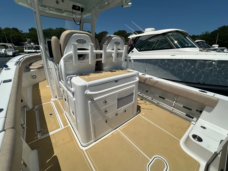 Slide: The Image of The image shows the cockpit of a 2019 Sportsman Open 282 Center Console boat with beige upholstery. - 26