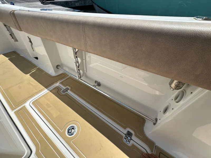 Slide: The Image of The image shows the deck of a 2019 Sportsman Open 282 Center Console boat with cushioned seating. - 28