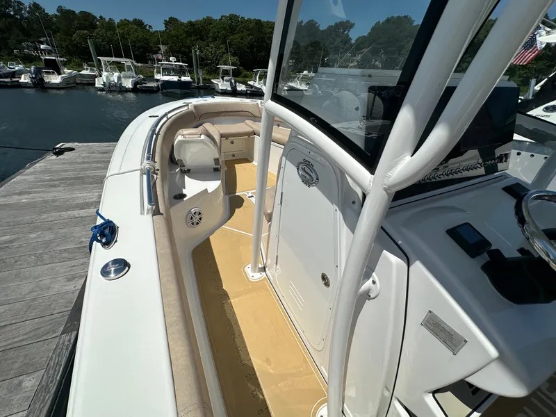 Slide: The Image of The image shows a 2019 Sportsman Open 282 Center Console boat docked at a marina. - 20