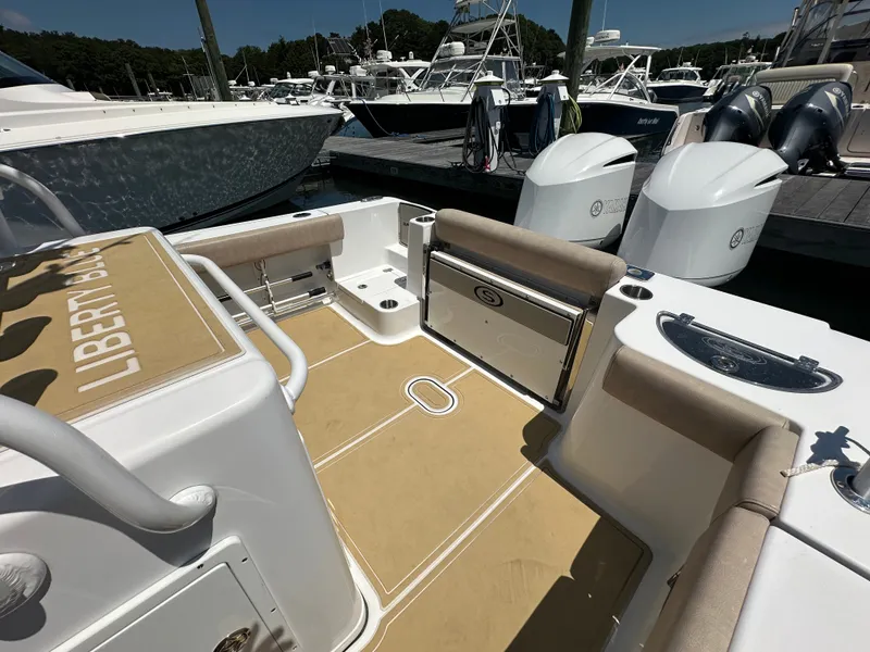Slide: The Image of The image shows the cockpit of a 2019 Sportsman Open 282 Center Console boat docked at a marina. - 23