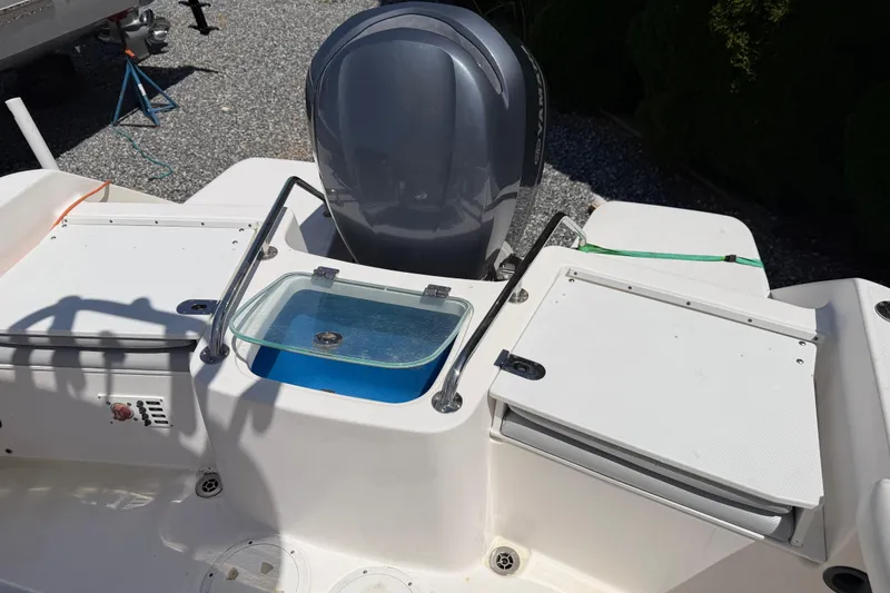 Slide: The Image of 2013 Everglades 210 Center Console boat with Yamaha engine and storage compartments. - 21