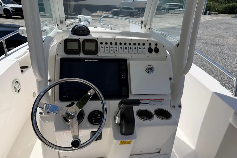 Slide: The Image of 2013 Everglades 210 Center Console boat dashboard with steering wheel and navigation controls. - 17
