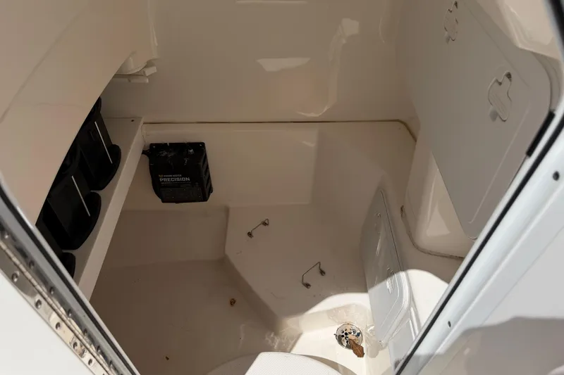 Slide: The Image of Interior of a 2013 Everglades 210 Center Console boat, featuring storage compartments. - 26