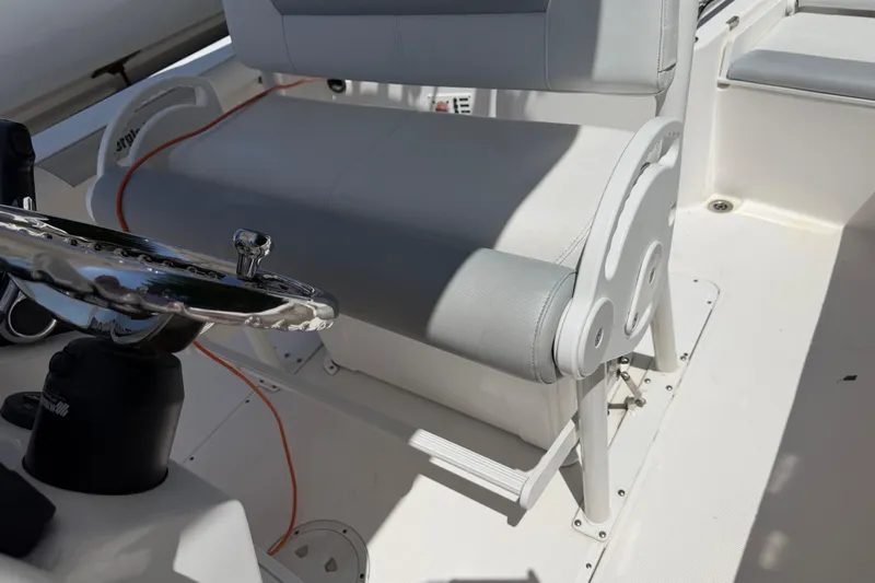 Slide: The Image of 2013 Everglades 210 Center Console boat interior with steering wheel and seating. - 19