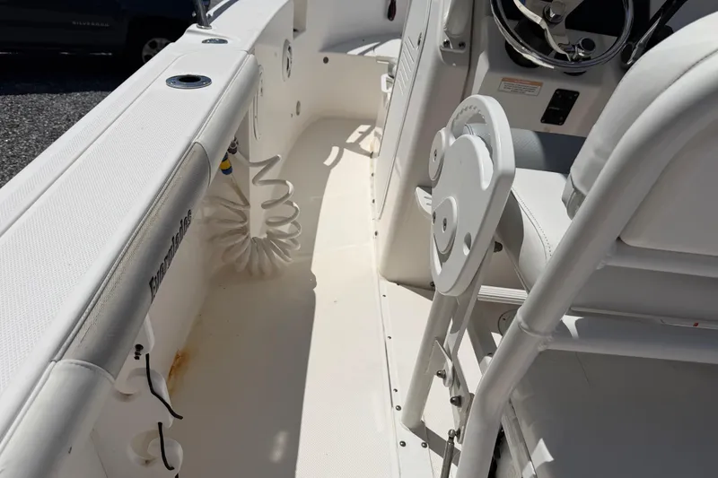 Slide: The Image of Interior view of a 2013 Everglades 210 Center Console boat, showcasing seating and steering area. - 24