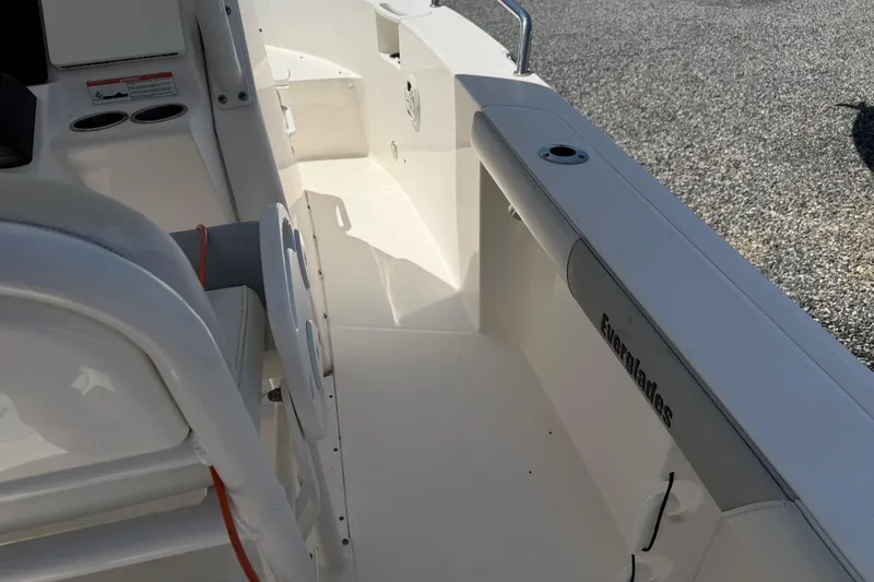 Slide: The Image of Interior view of a 2013 Everglades 210 Center Console boat, showcasing seating and deck details. - 23
