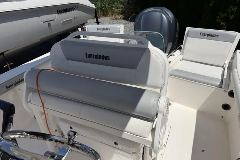 Slide: The Image of 2013 Everglades 210 Center Console boat interior with seating and steering wheel. - 18