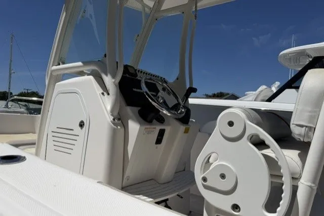 Slide: The Image of 2013 Everglades 210 Center Console boat interior with steering wheel and controls. - 7
