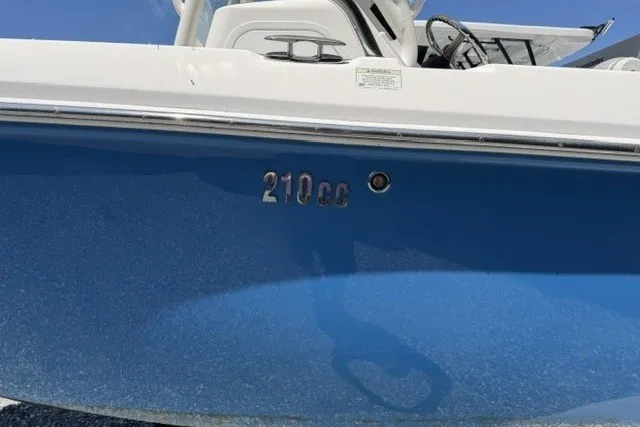 Slide: The Image of 2013 Everglades 210 Center Console boat with blue hull and visible model number. - 5