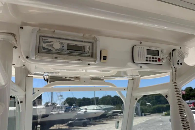 Slide: The Image of 2013 Everglades 210 Center Console boat dashboard with radio and communication equipment. - 25