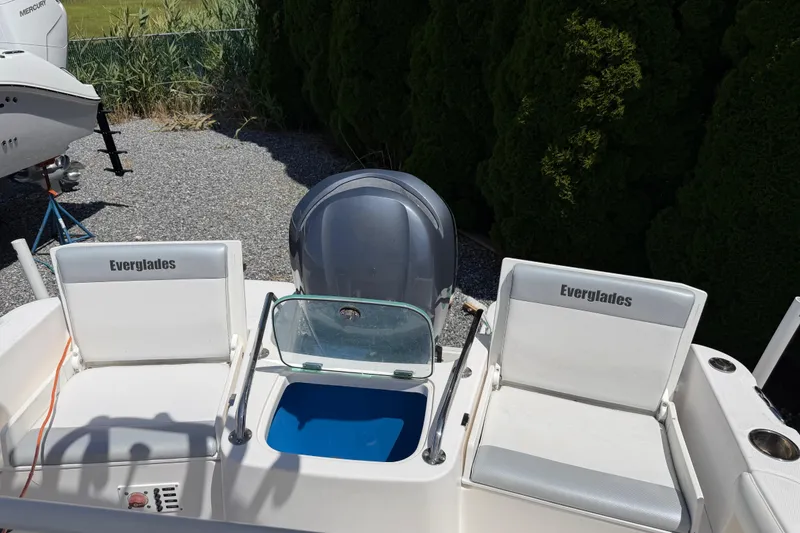 Slide: The Image of 2013 Everglades 210 Center Console boat interior with seating and motor. - 20