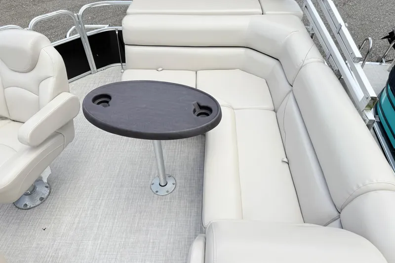 Slide: The Image of 2019 South Bay 520CR boat interior with beige seating and oval table. - 9