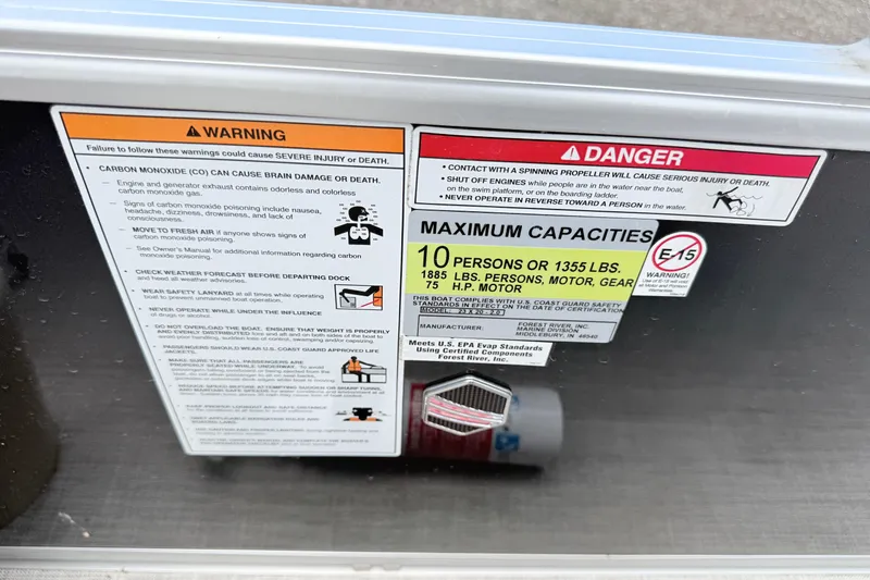 Slide: The Image of Warning and capacity labels on a 2019 South Bay 520CR boat. - 12