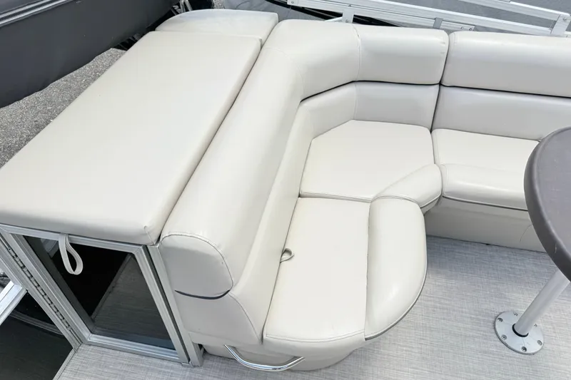 Slide: The Image of 2019 South Bay 520CR boat interior with white leather seating and table. - 14