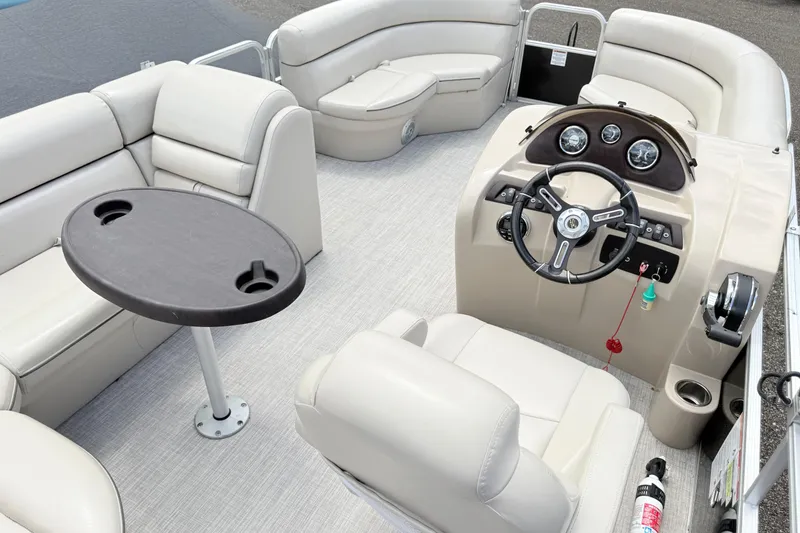 Slide: The Image of 2019 South Bay 520CR pontoon boat interior with steering console and seating area. - 15