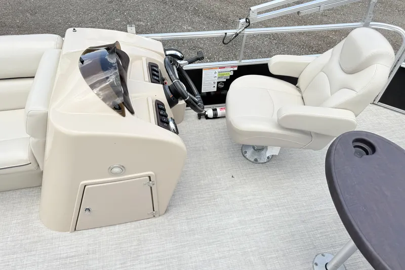 Slide: The Image of 2019 South Bay 520CR boat interior with helm, captain's chair, and table. - 10