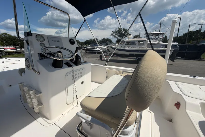 Slide: The Image of 2019 Sea Born SV19 Bay boat interior with steering console and cushioned seating. - 11