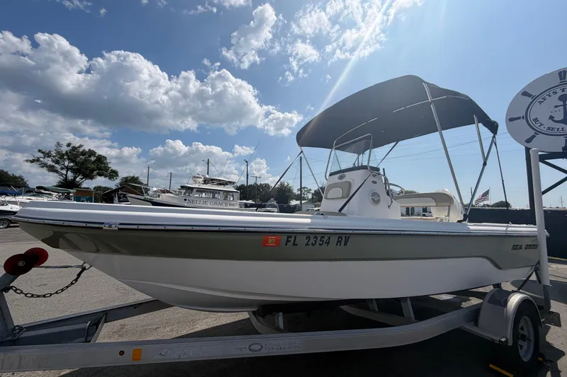 Slide: The Image of 2019 Sea Born SV19 Bay boat on trailer under a sunny sky. - 7