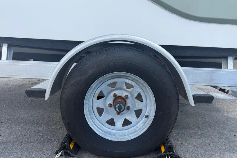 Slide: The Image of Trailer wheel of a 2019 Sea Born SV19 Bay boat on pavement. - 61