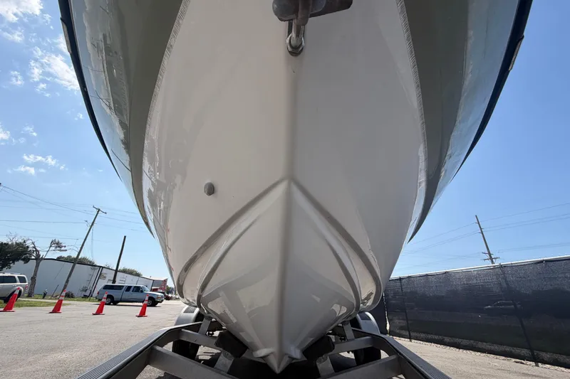 Slide: The Image of 2019 Sea Born SV19 Bay boat on trailer, viewed from below, under clear sky. - 9