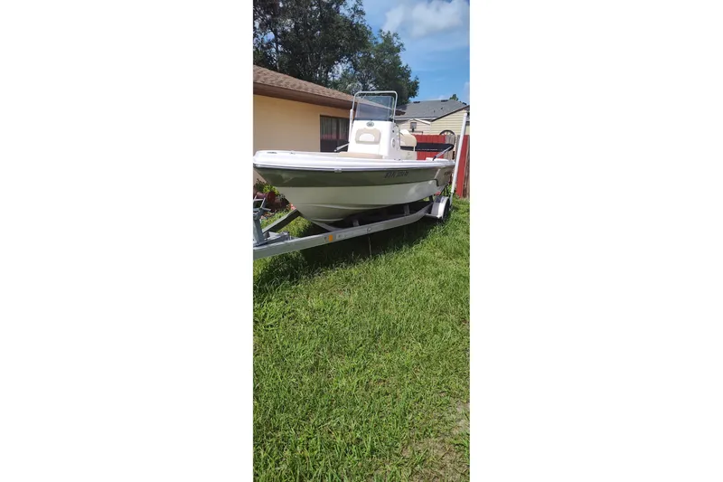 The Image of 2019 Sea Born SV19 Bay boat on trailer, parked on grass beside a house. - 0