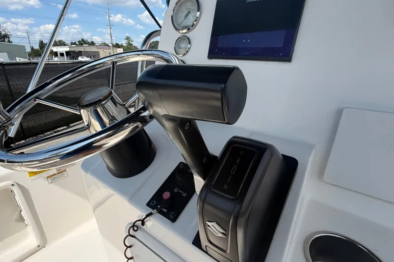Slide: The Image of 2019 Sea Born SV19 Bay boat helm with steering wheel and throttle controls. - 21